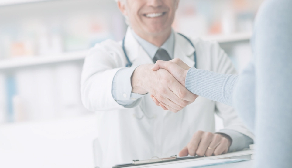 Pharmacist shaking hands with customer