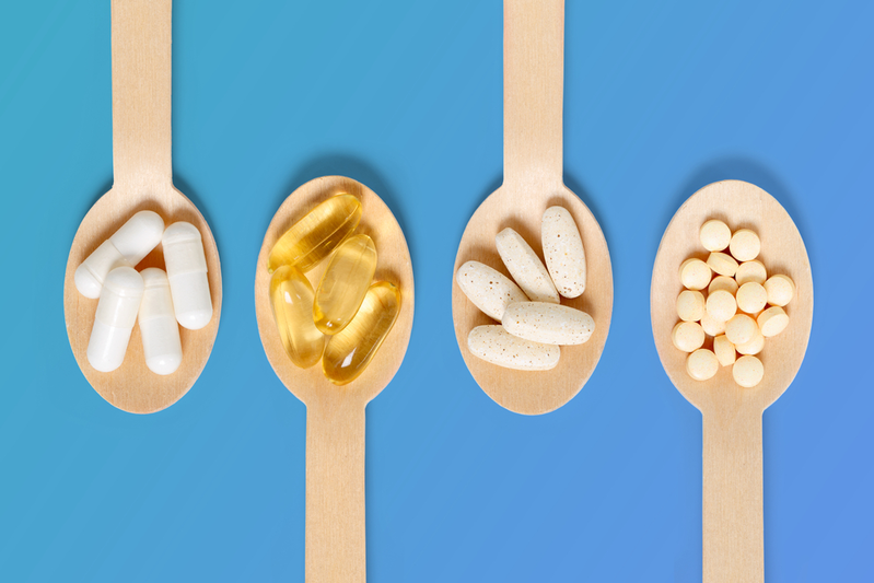 four different medicines on wooden spoons
