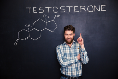man pointing toward blackboard with testosterone written on it