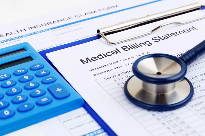 Stethoscope sitting on medical billing statement next to a calculator