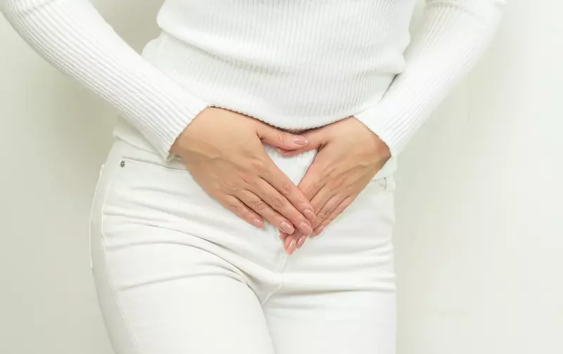 Bladder Incontinence - Woman in White Holding Her Bladd
