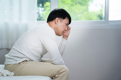 man sitting on bed