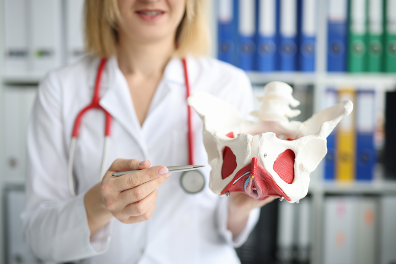 Woman holding pelvic muscle