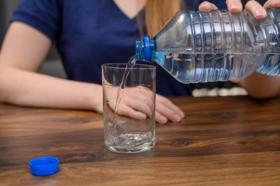 woman pouring glass of water