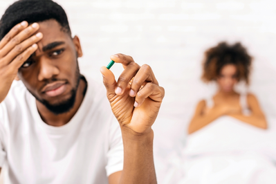 man holding ED medication