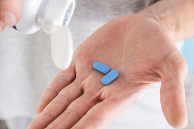 blue pills in hands