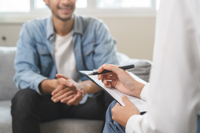 smiling man talking to a doctor