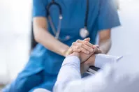 nurse holding hands with a patient