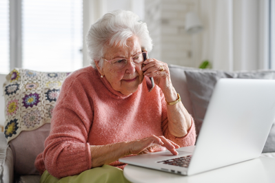 elderly woman browses internet