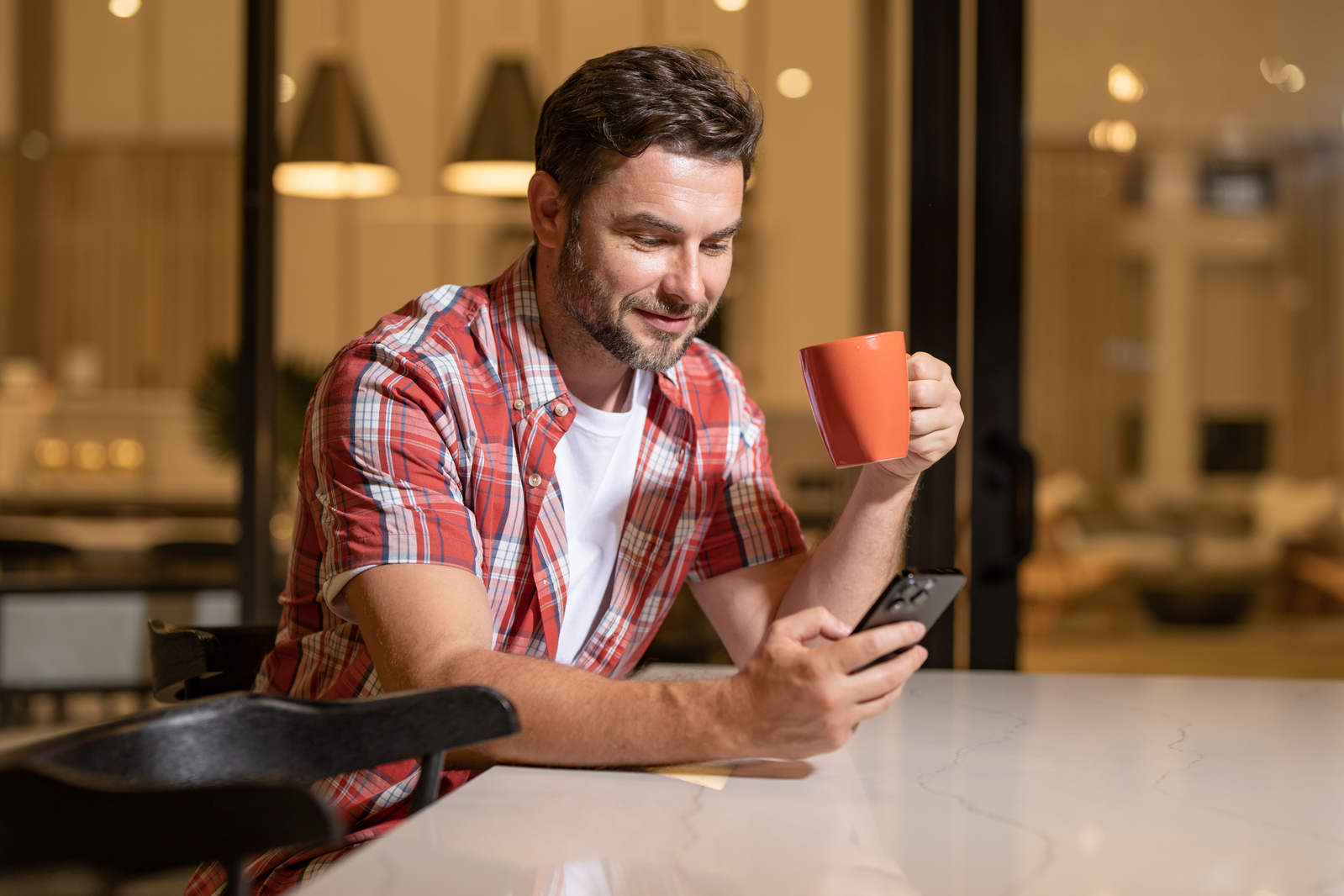 man with coffee on his phone