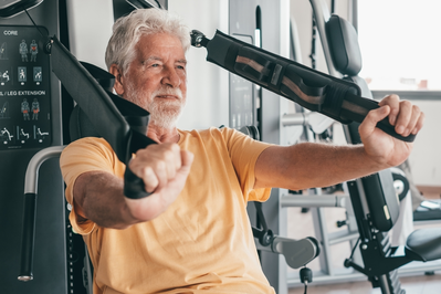 older man lifting weights