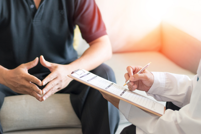 urologist discusses Peyronie's disease with patient