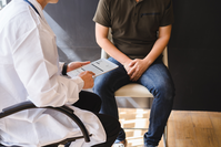 doctor chats with patient about peyronie's disease